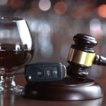 A glass of wine and car keys, signifying a DUI